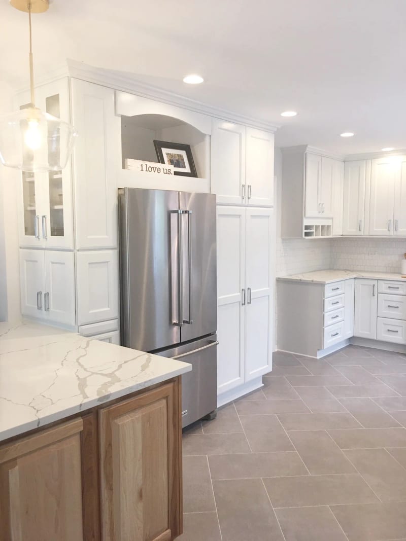Lake Bluff cottage kitchen with white cabinets and a natural oak island