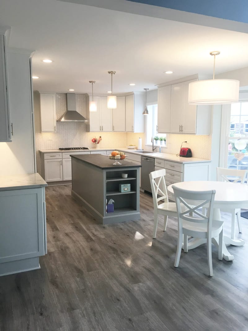 Northbrook kitchen with white shaker cabinets and a gray island with open shelving