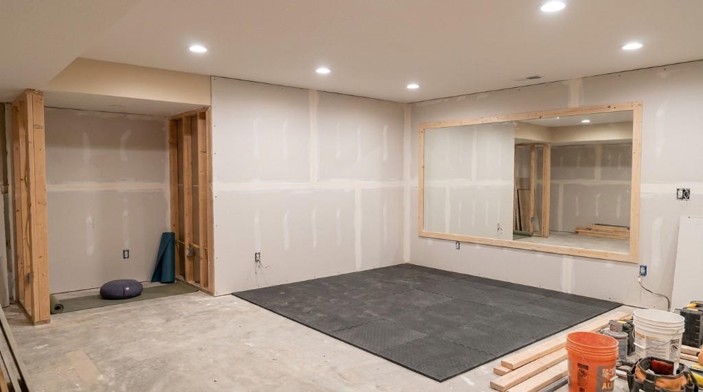 Basement home gym with yoga corner and rubber flooring in Illinois