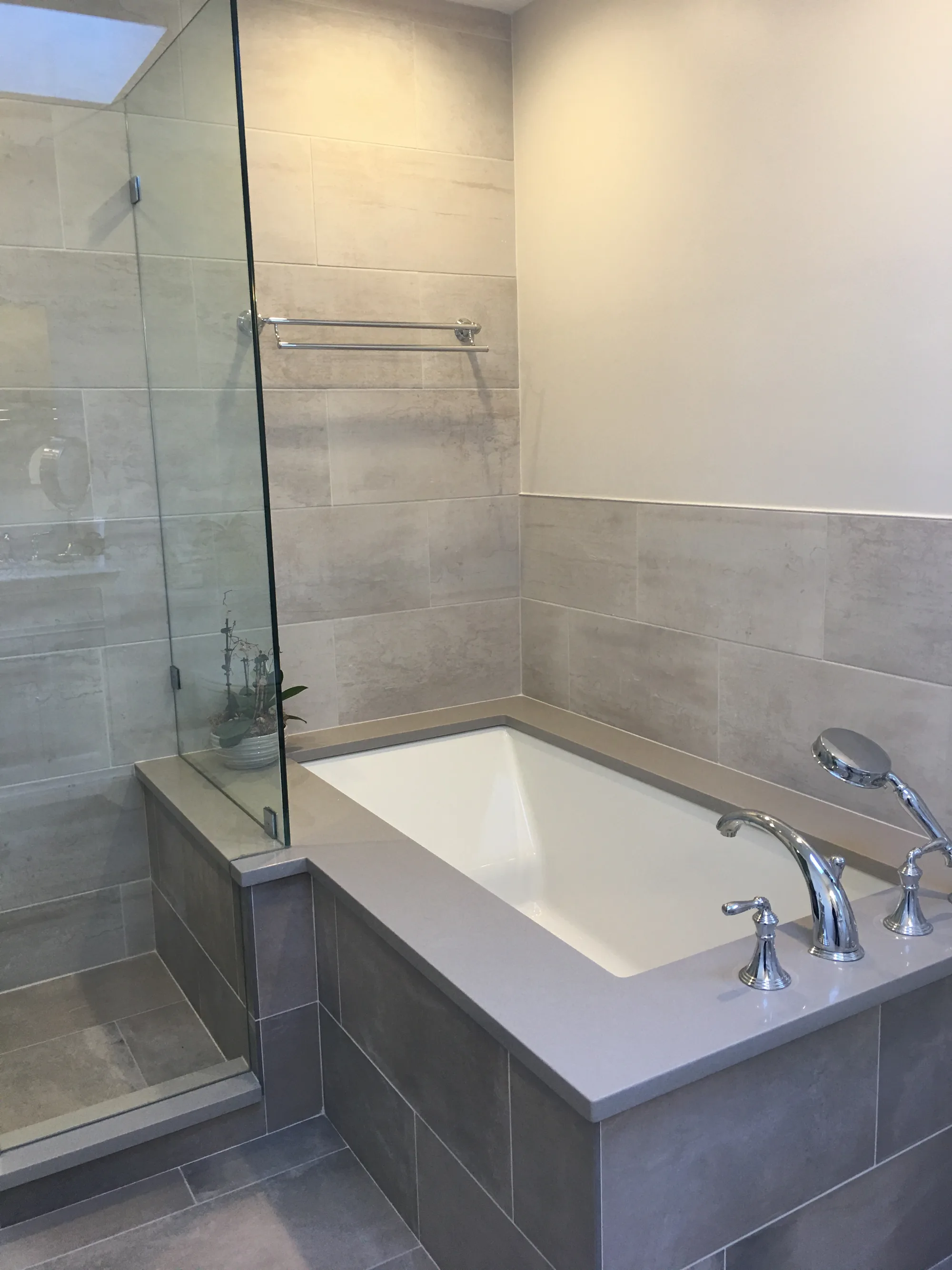 Lake Forest bathroom: herringbone marble accent niche inside porcelain-tile walk-in shower