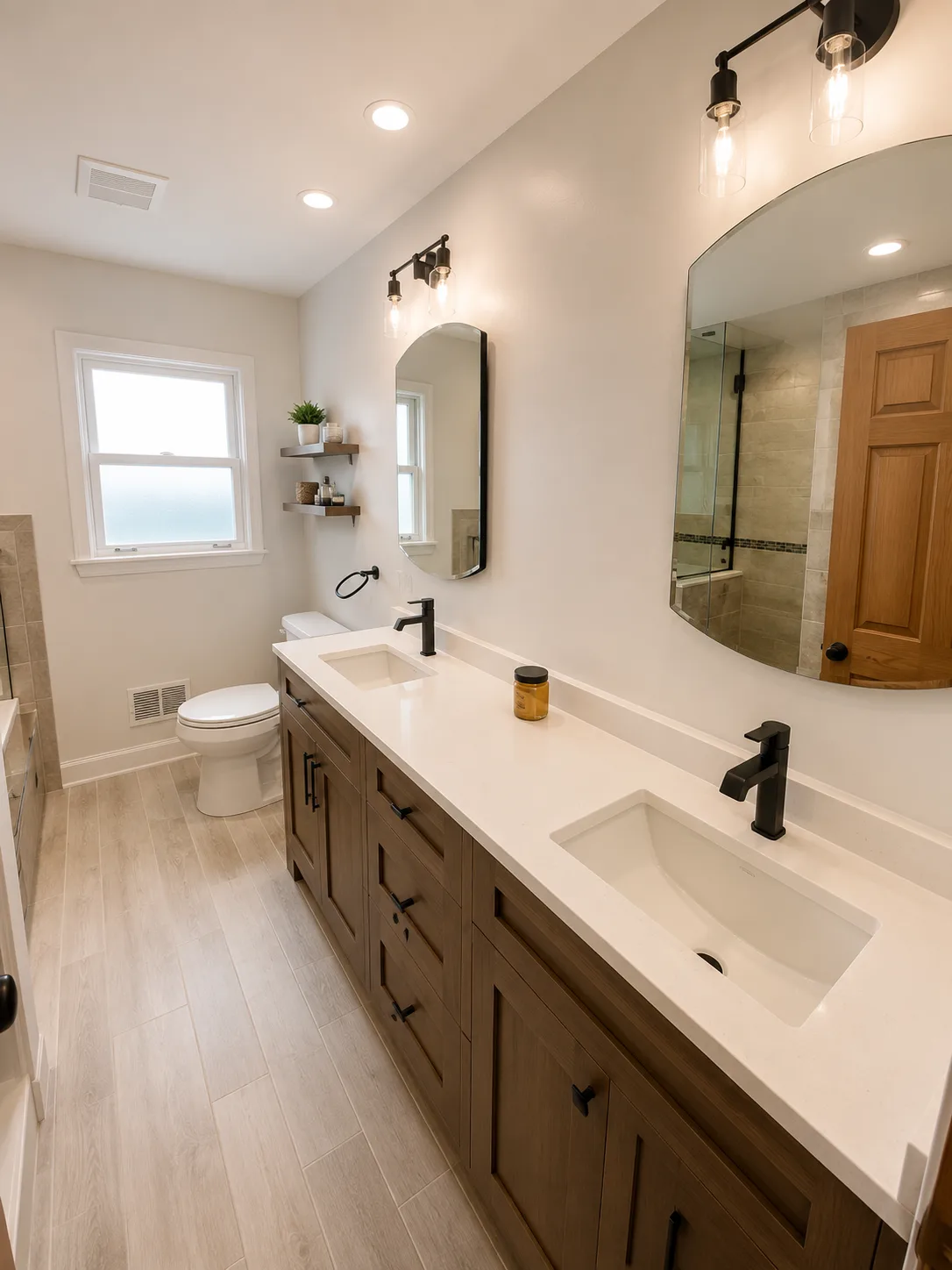 Completed Highland Park bathroom remodel with a walnut double-sink vanity, quartz countertop, and matte black fixtures