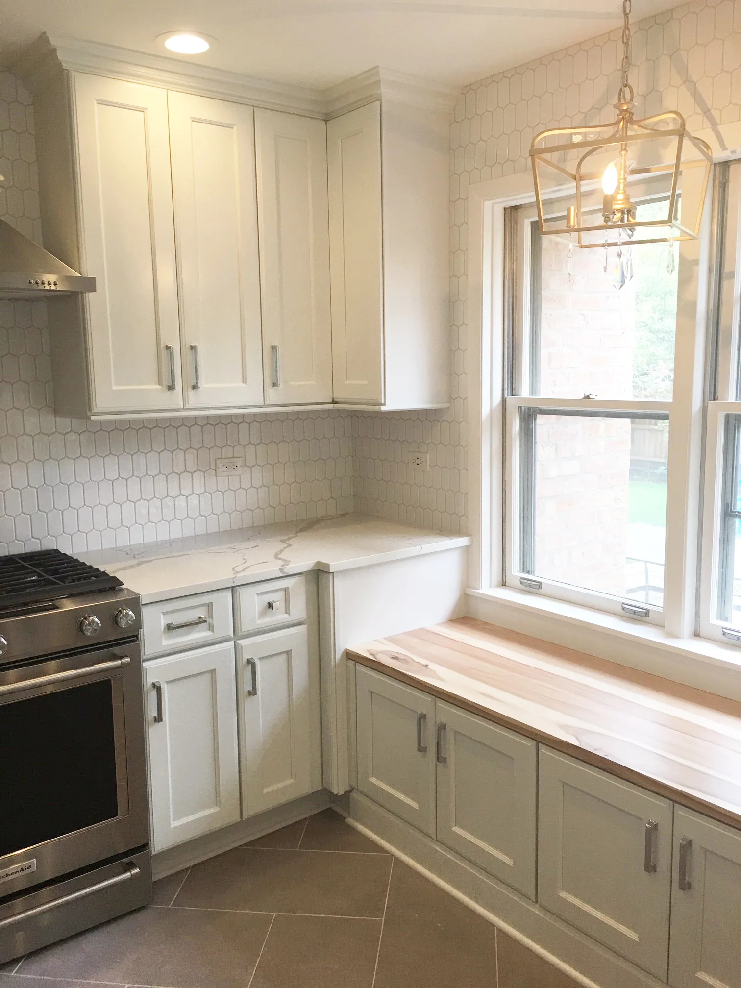 Lake Bluff kitchen: arched display niche above stainless French-door refrigerator