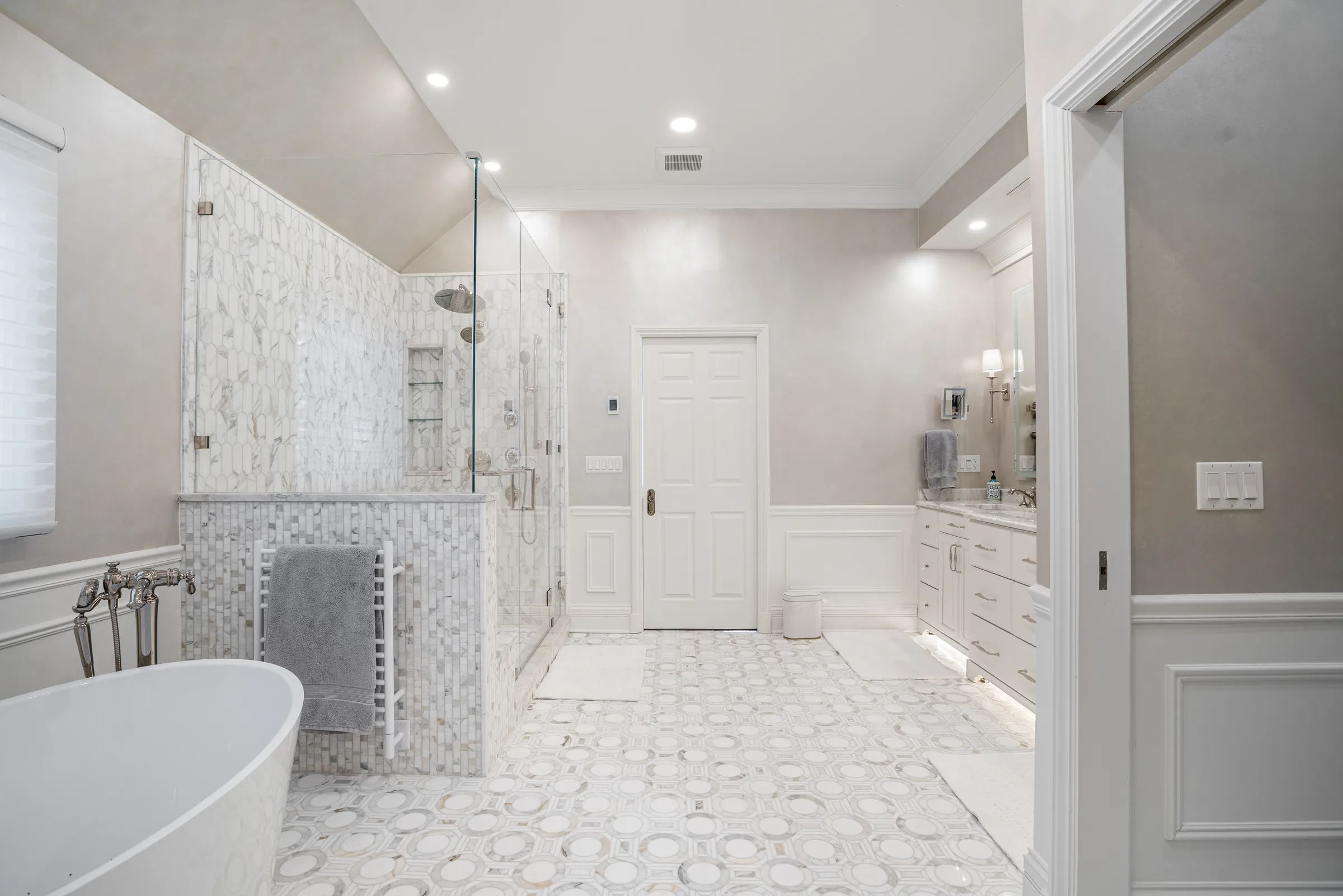 Lake Forest bathroom remodel: walk-in glass shower with marble walls