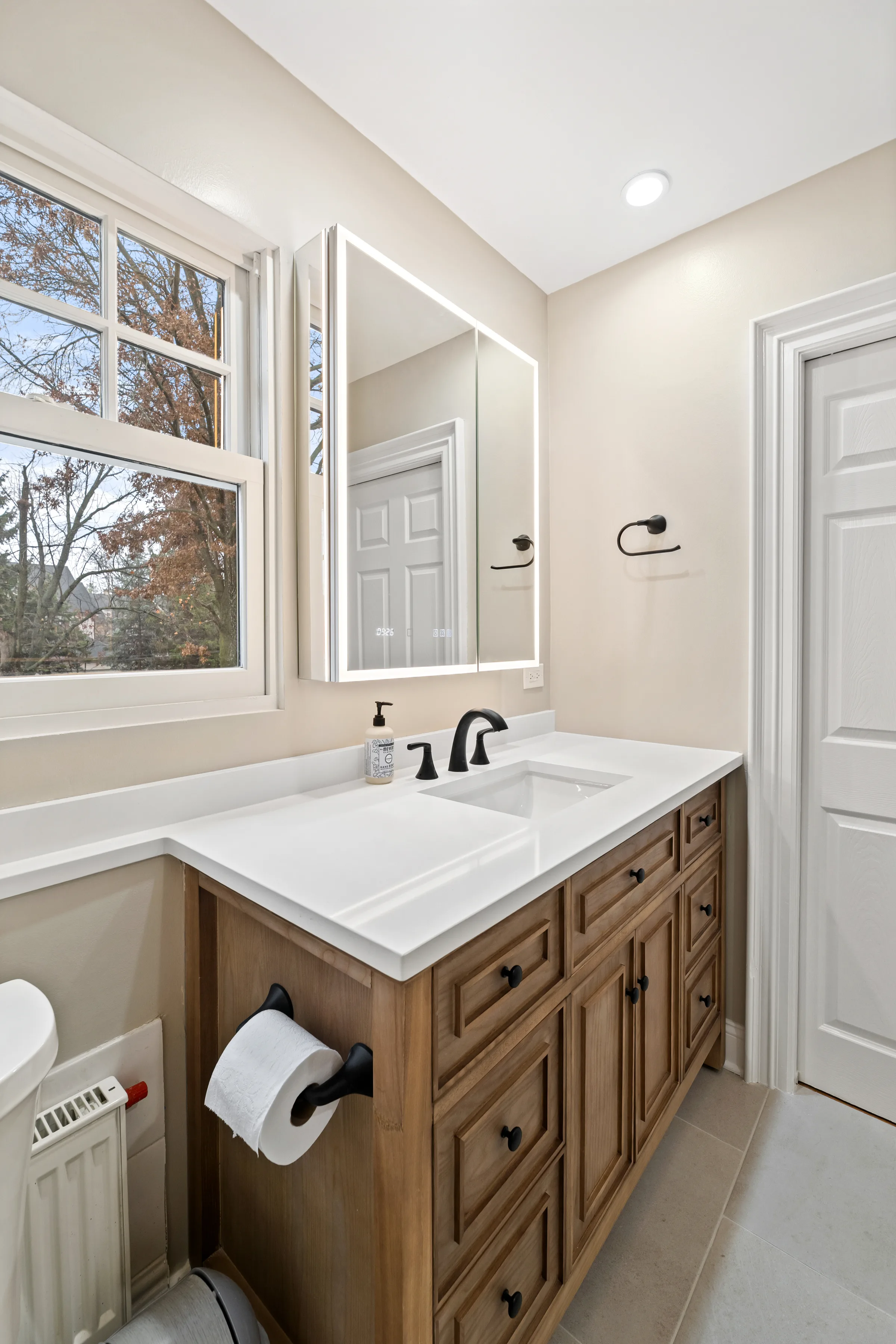 Northbrook bathroom remodel: tile base and cabinetry hardware detail