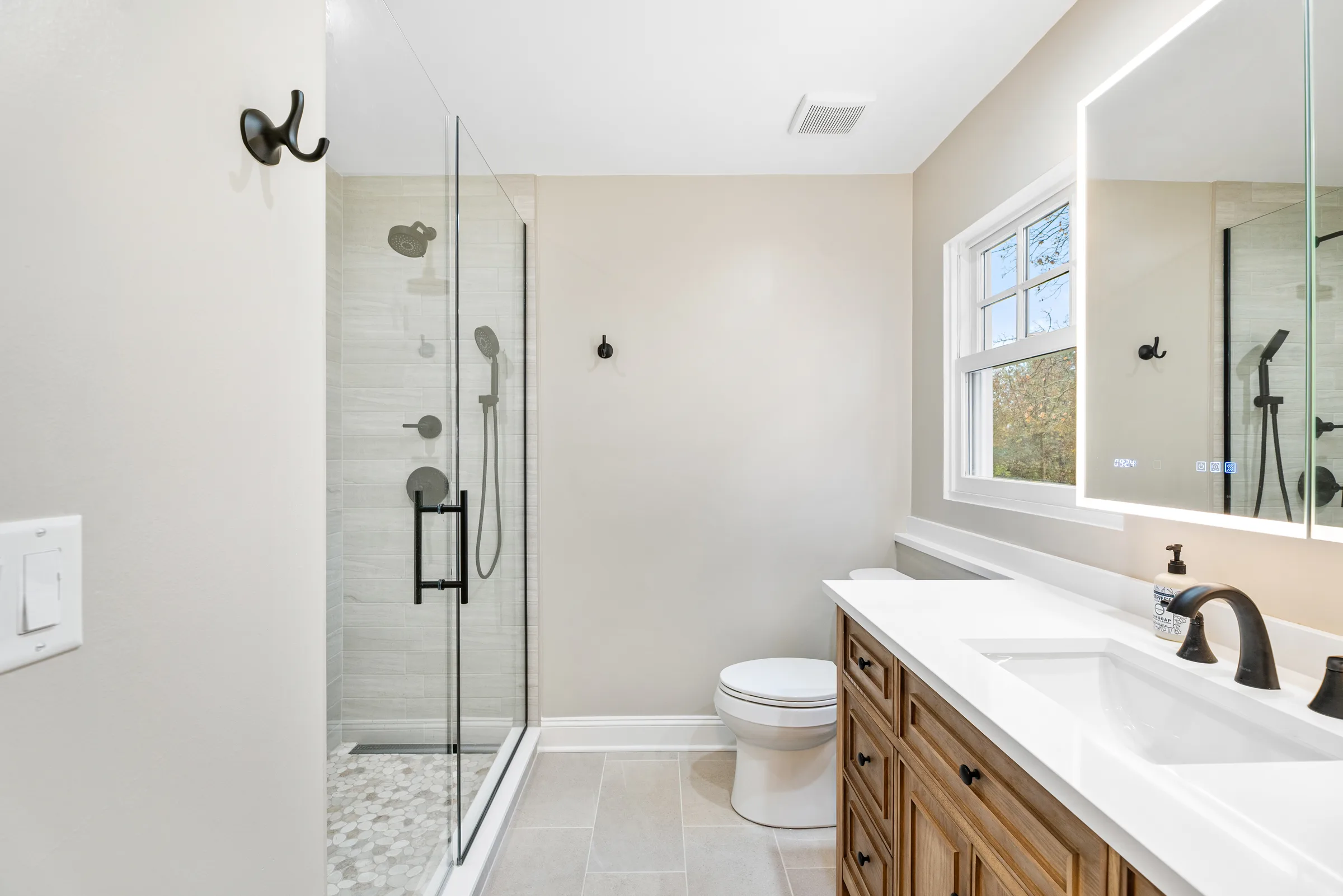 Northbrook bathroom remodel: walk-in ceramic shower with bronze fixtures