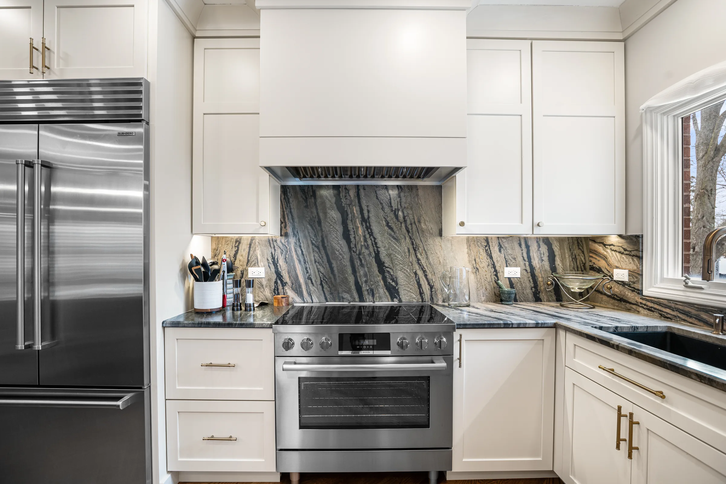 Lake Forest kitchen remodel: marble-topped walnut island with brass pendants