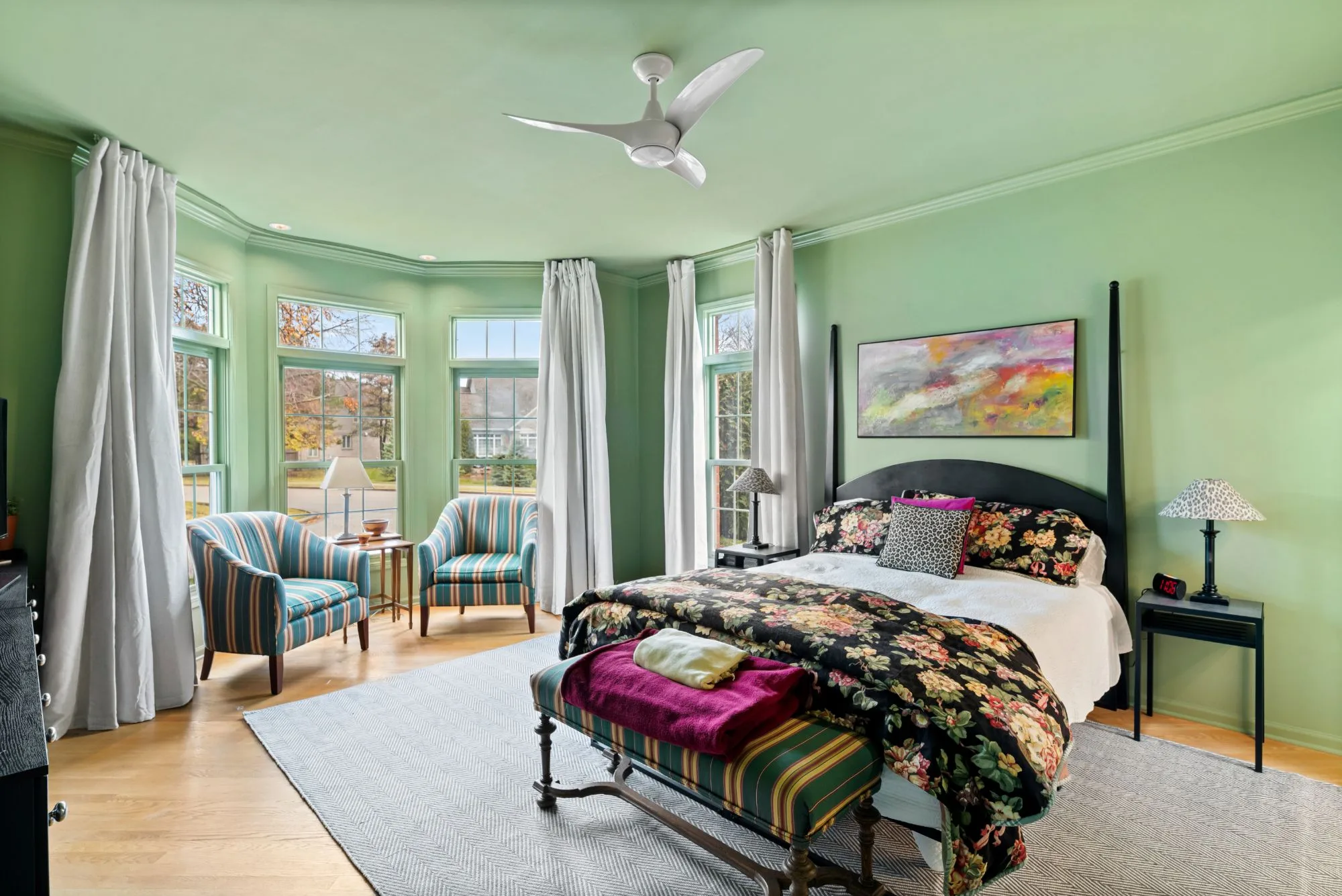 Northbrook primary bedroom with sage-green walls and ceiling, crown molding and a bay window