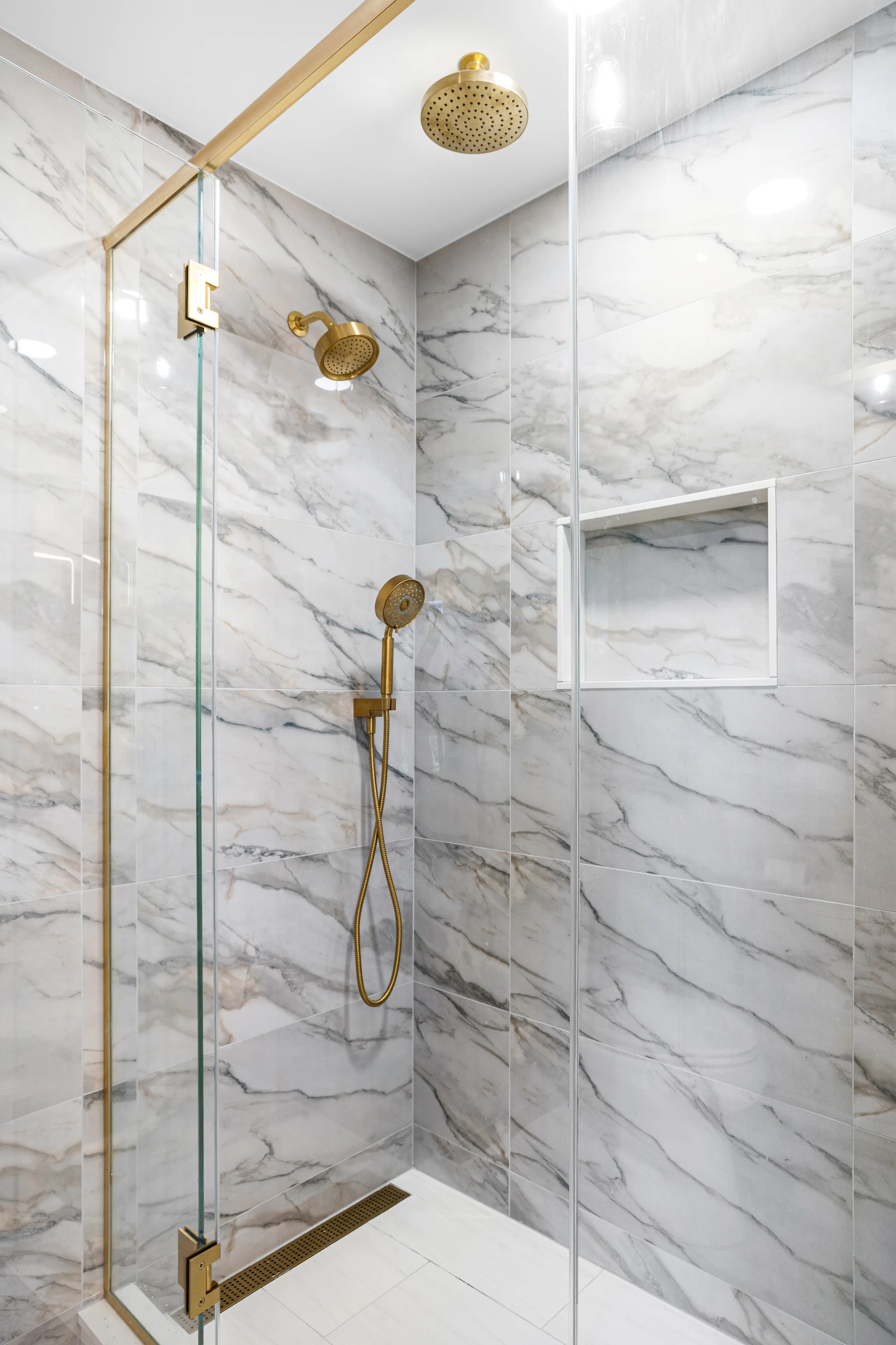 Lake Forest bathroom remodel: brushed brass faucet and Kohler sink close-up