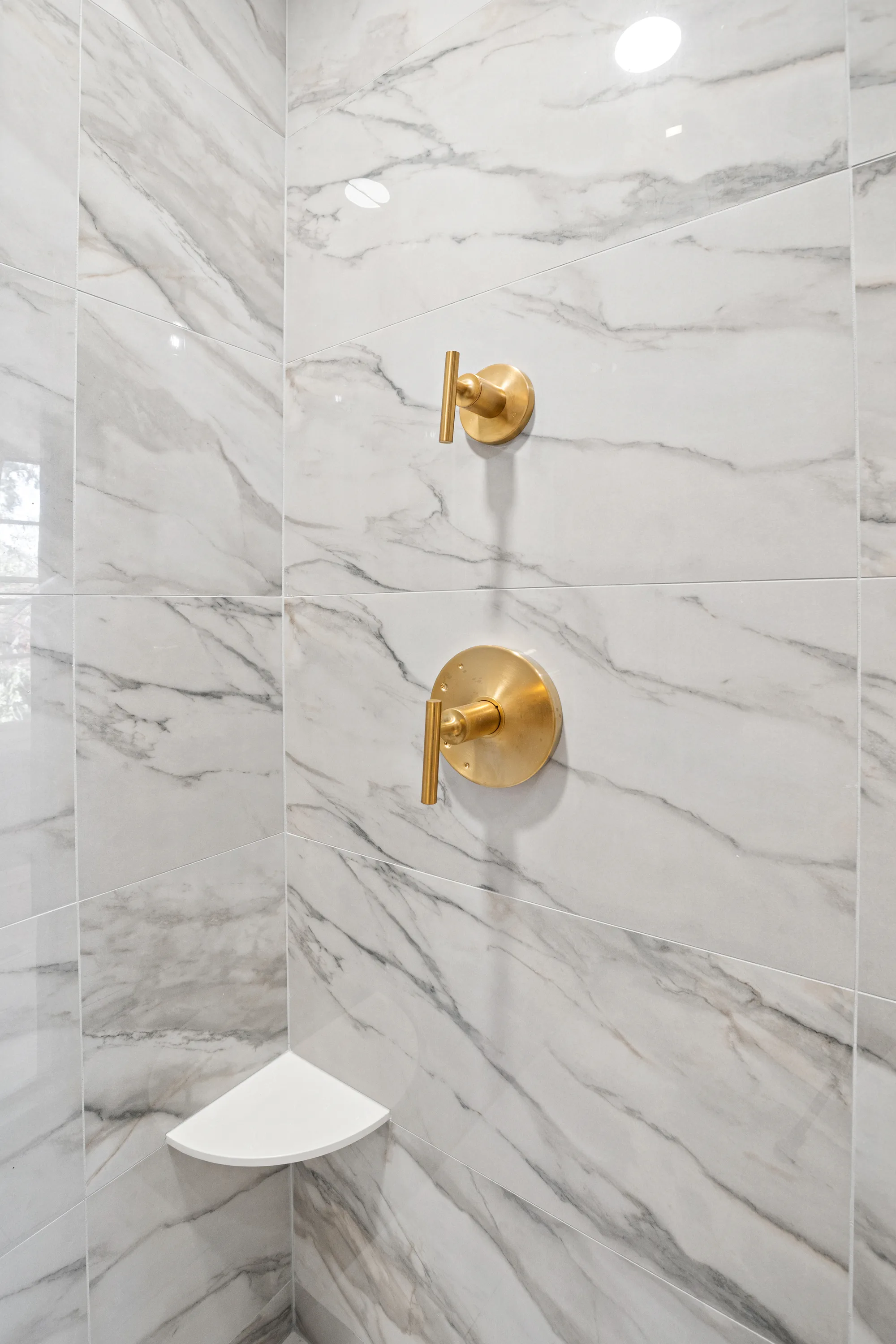 Wilson Road bathroom Lake Forest: brushed brass faucet detail over white quartz counter